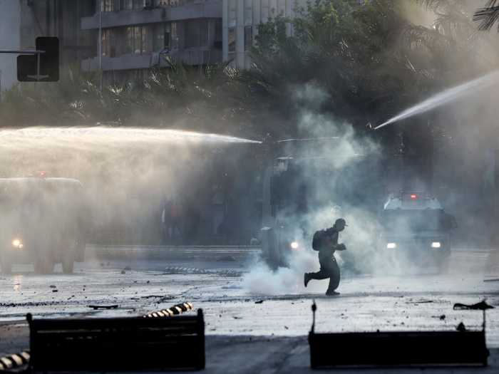 Military and their armed vehicles tried to push back protesters and clear the streets using tear gas and water cannons.