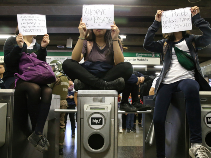 But on Monday, students started to protest through Santiago, Chile in a mass fare-evasion campaign, jumping over and dipping under turnstiles in the subway to avoid paying.