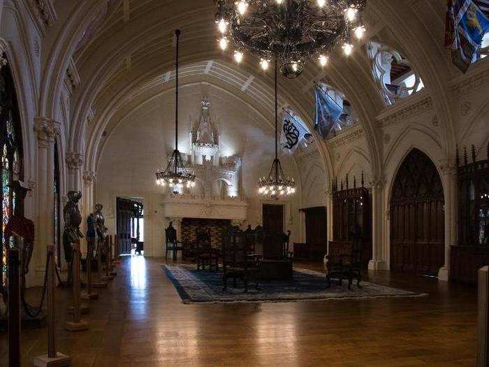 The vaulted ballroom measures 2,000 square feet and features original chandeliers and stained glass windows. It took a team of five a month to clean the room, and the restoration process isn