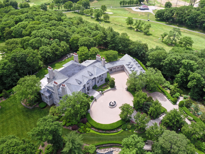 The house can accommodate up to 24 cars in the attached four-car garage and the circular driveway.