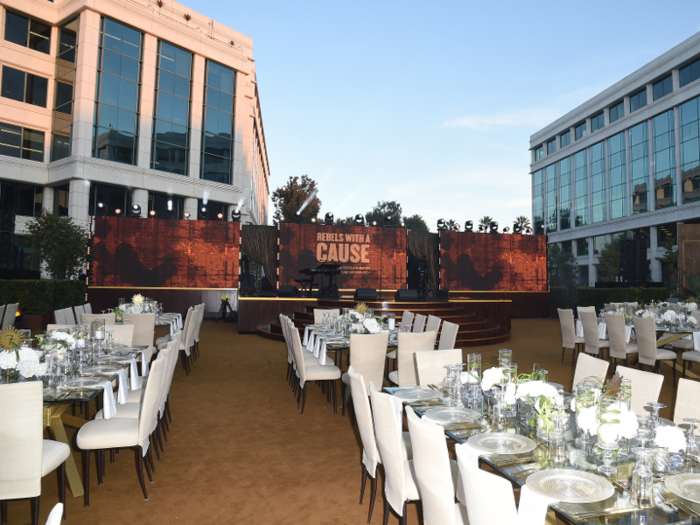 The glass tables were decorated with silver accessories and white flowers; the event was designed by AOO Events.