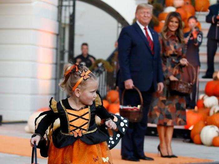 One child dressed as a butterfly appears to be running with her candy loot.