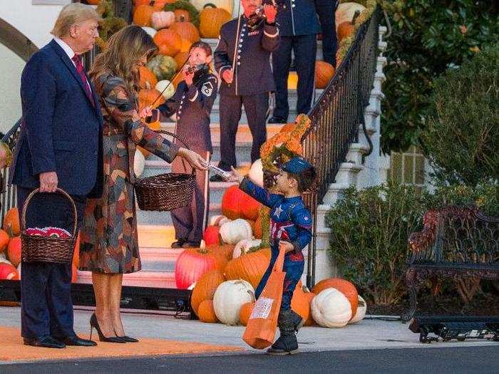 The Trumps were met by children in a variety of costumes, including Captain America from 