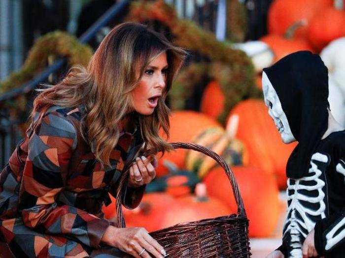 The first lady marvels at the skeleton costume of a trick-or-treater.