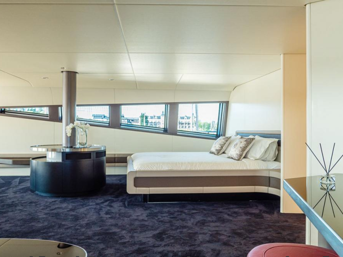 The palatial master suite showcases windows that provide maximum light and ocean views ...