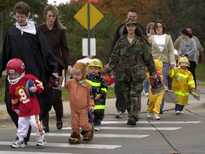 (2001) Omaha, Nebraska, trick-or-treaters cross the street.