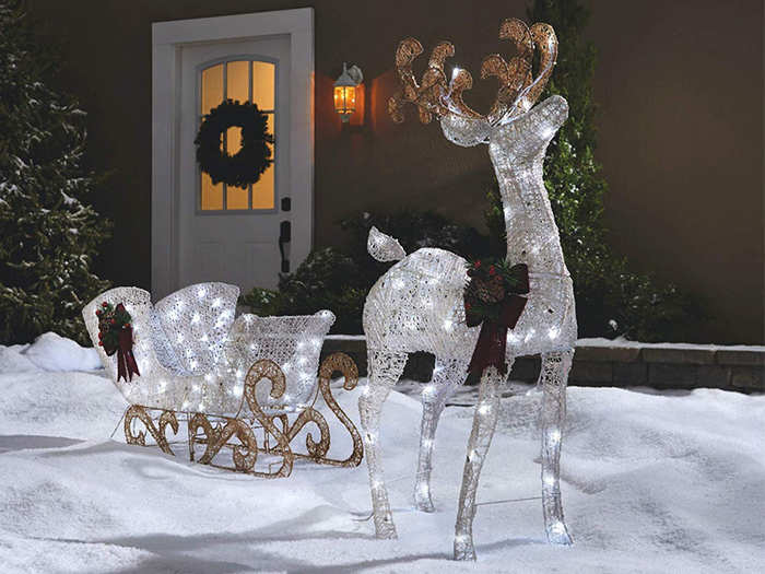 A lighted reindeer and sleigh lawn decoration