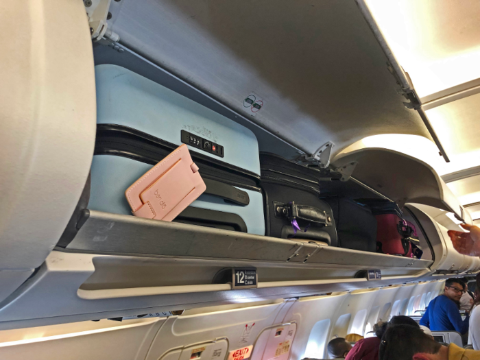 My flight was completely full, so there was limited overhead space. The crew announced that people would have to check their bags at the gate — thankfully mine fit beautifully in the compartment above.