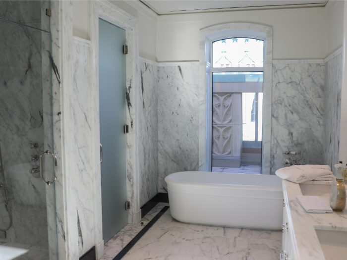 The marble master bathroom comes with a freestanding soaking tub, a steam shower, dual vanity, and radiant heat flooring.