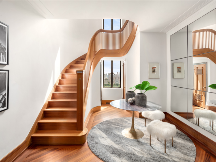 A curving staircase connects the three levels of the home.