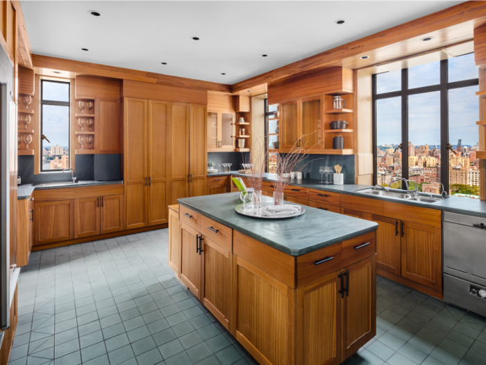 The kitchen features wooden cabinetry and a large center island.