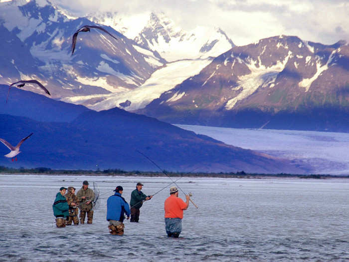 An ecological consequence, for example, could be the effect glacial melt could have on salmon populations. Here, fisherman in Alaska try to catch silver salmon with the Knik glacier out in front of them.