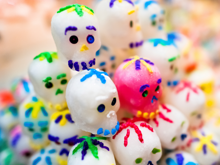 In addition to cempasúchiles, people celebrating the Day of the Dead also buy pecked paper, sugar skulls, tequila, and the traditional pan de muertos, which is a traditional sweet bread.