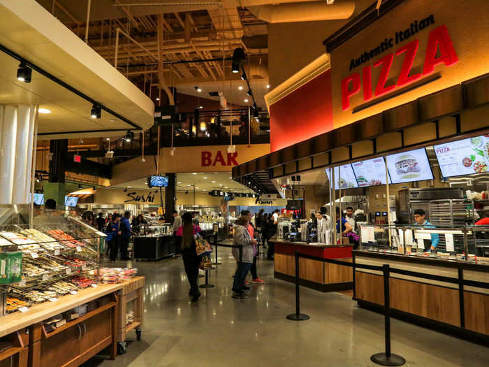 The "Authentic Italian Pizza" counter sells slices of pizza, but it also sells fresh-baked custom pies in three sizes, including personal.