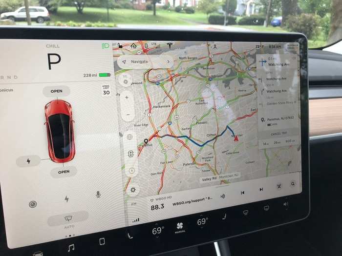 The large, central touchscreen handles almost all vehicle functions. The left side is reserved for the readouts you