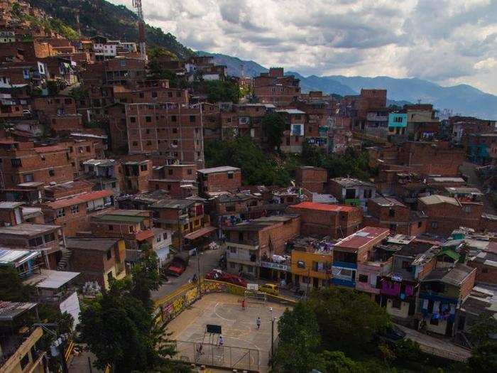 Riding up the mountains, you can see art on rooftops and amenities like public sports pitches.