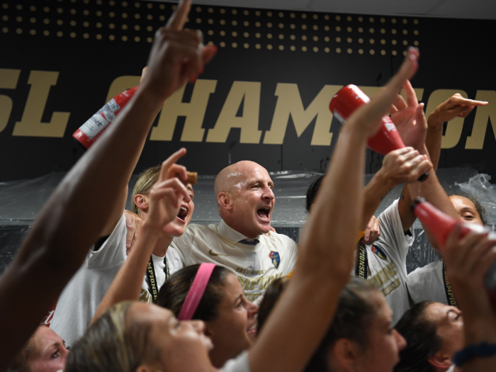 Head coach Paul Riley even joined in as the bottles started popping.