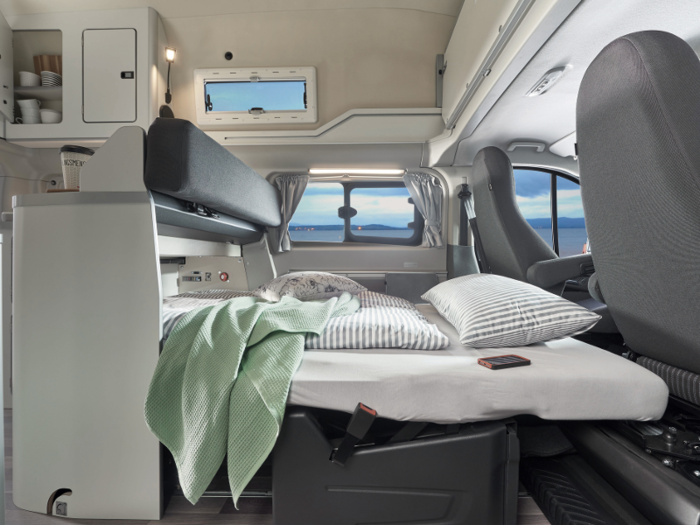 The van includes rear privacy glass, second row flip-open windows, and a heated window for the tailgate.