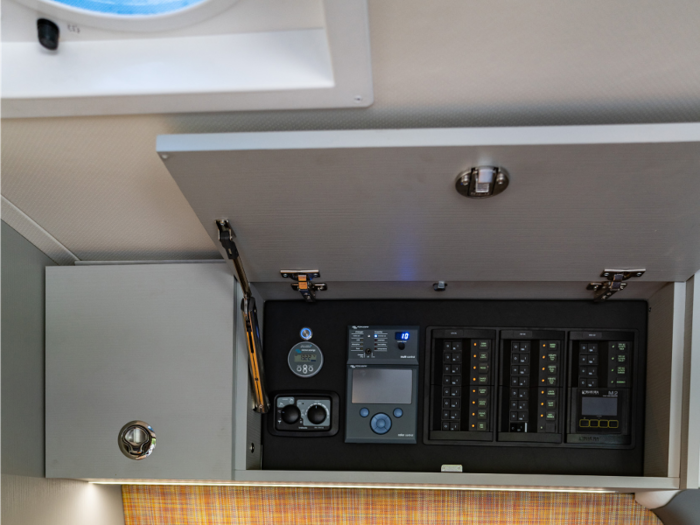 All systems on the van are controlled by the “Command Centre” that’s hidden behind a cabinet. The center includes monitors that display battery levels, solar and alternator input, and the status of the heating, hot water, and grey water tanks.