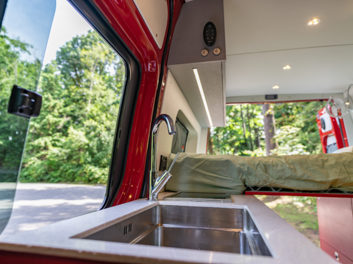 There is a 46-gallon, steel water tank that services water to the camper. The tank is placed where the factory spare tire would normally be, and the tire has been moved to a custom rack on the back of the van.