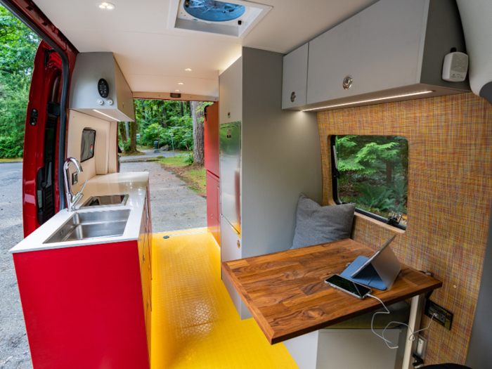 The kitchen is equipped with a ceramic diesel stove, sink, Vitrifrigo refrigerator-freezer, and microwave.