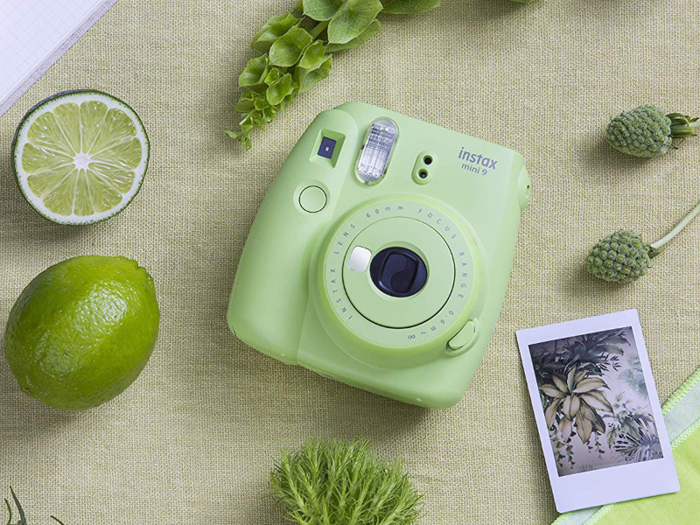 An instant camera with a selfie mirror and flash