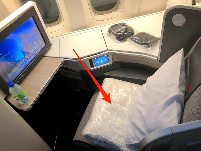 Once I boarded, I found my seat, which had a plastic-wrapped package of blankets and a sleeping mat sitting on it.