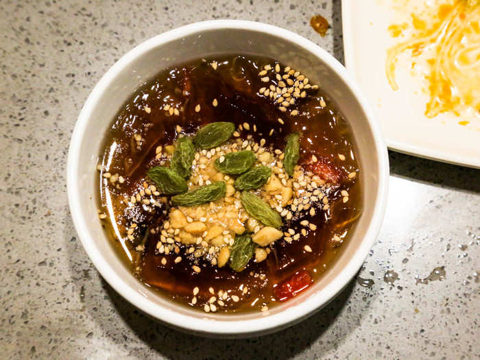 I made one last trip to the sauce bar for dessert: a bowl of fruity grass jelly topped with crushed peanuts, sesame seeds, and raisins.