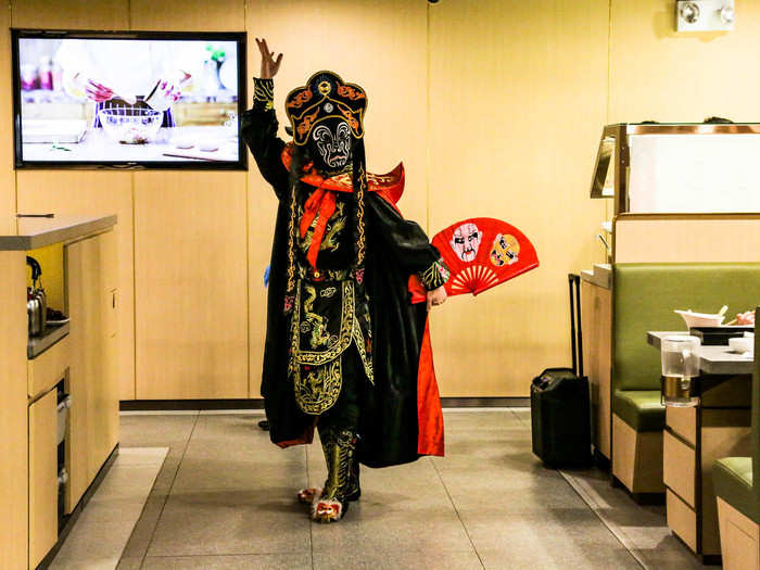 A costumed performer entered the dining space and began dancing to bombastic Chinese opera music.