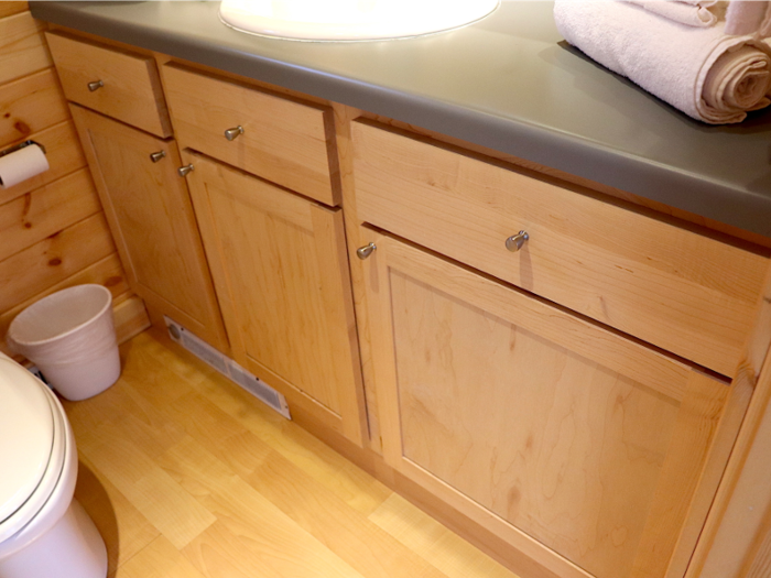 The tiny house takes the gold in the bathroom: It was full of storage. There were two cabinets above the sink and a row of cabinets — plus drawers — underneath it.