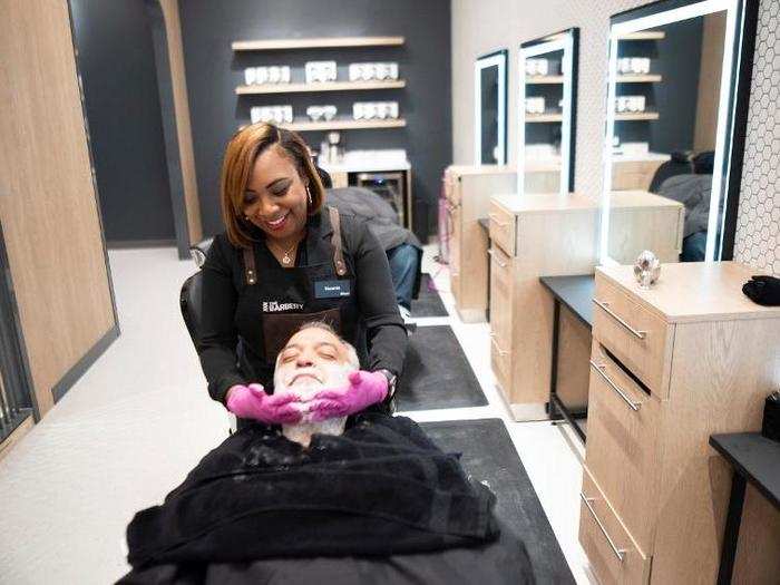 A customer gets his beard shaved and styled at The Barbery during its grand opening.