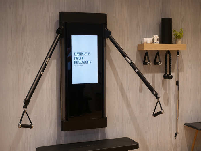 The Tonal machine looks a lot like a flat-screen TV with two handlebars protruding from its sides. They