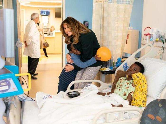 November 6: Melania Trump hugs a child while visiting the pediatric wing of Boston Medical Center.