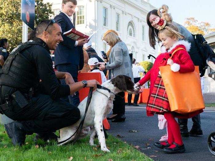 October 28: A little girl dressed as Sally Lou Who pets a security guard during White House Halloween festivities.