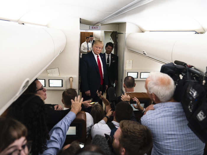 August 15: Trump talks to members of the media aboard Air Force One following a trip to Manchester, New Hampshire.