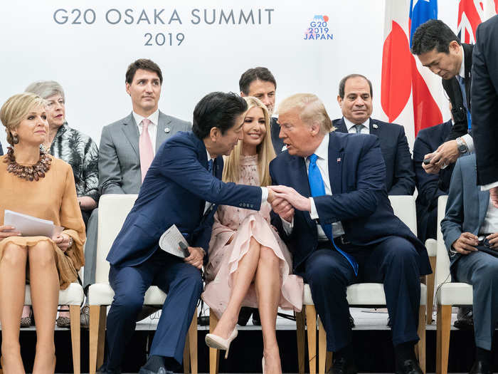 June 28: Shinzo Abe, prime minister of Japan, reaches over Ivanka Trump to shake the hand of her father.