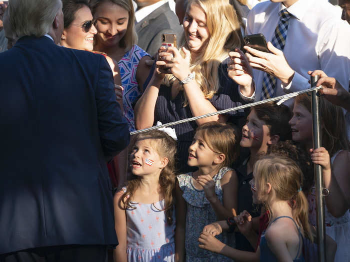 June 21: A group of girls stare up in adoration at Trump as he greets guests on the South Lawn for the 2019 Congressional Picnic.