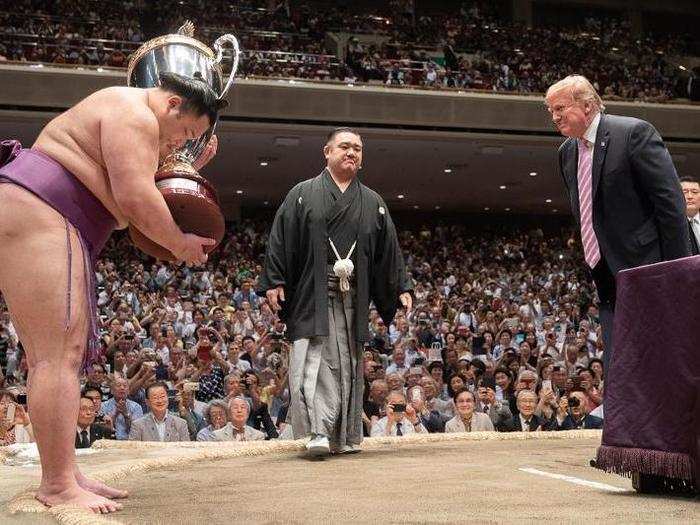 May 26: Trump bows to a Sumo wrestler after taking in a fight in Japan.