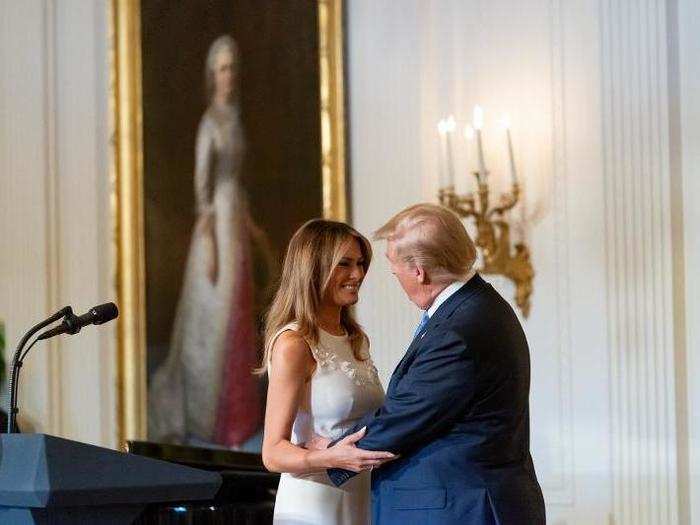 May 10: Trump hugs his wife while a portrait of the first first lady, Martha Washington, hangs in the background.