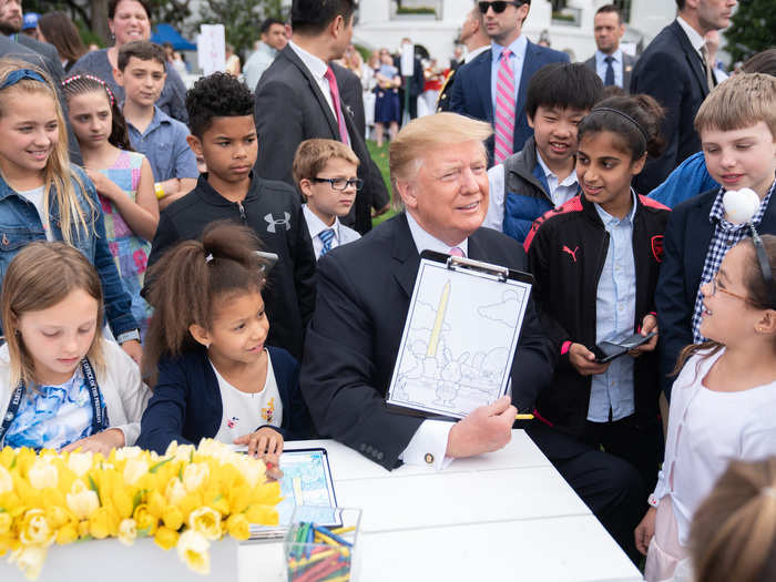 April 22: Trump shows off his coloring skills to children gathered for the annual White House Easter Egg Roll.