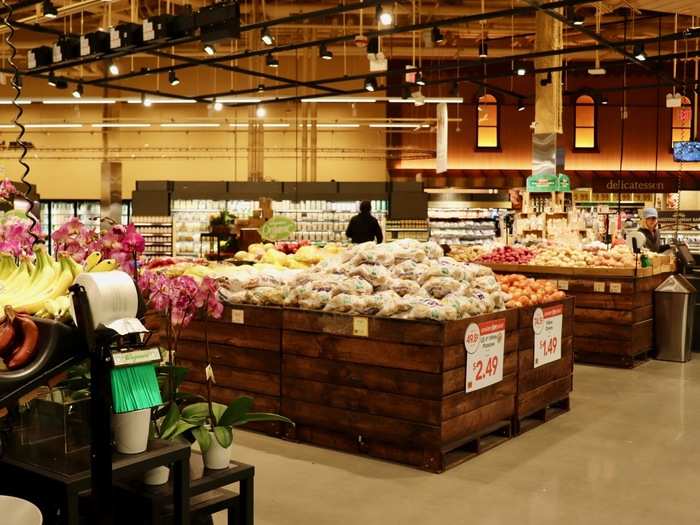The warm lighting and dark wood finish of the food displays helped establish this theme. Plus, the store walls had the facade of a building and marketplace, complete with canopies and windows that were lit from the inside.