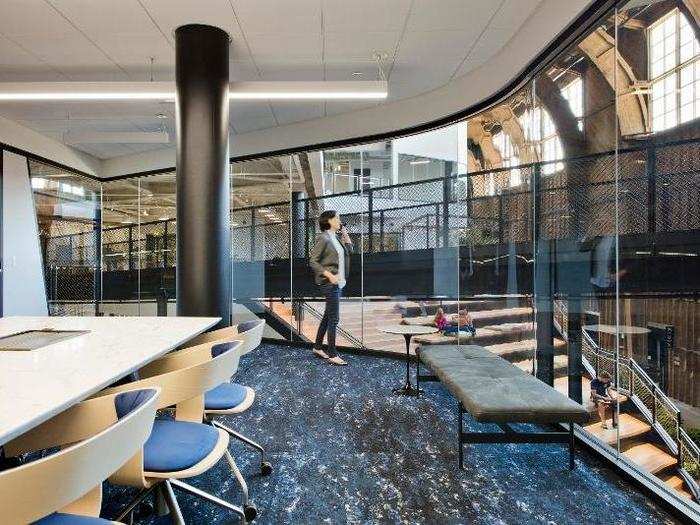 Offices are set back from the main atrium near the spine of the building, but glass walls still give a sense of the space.