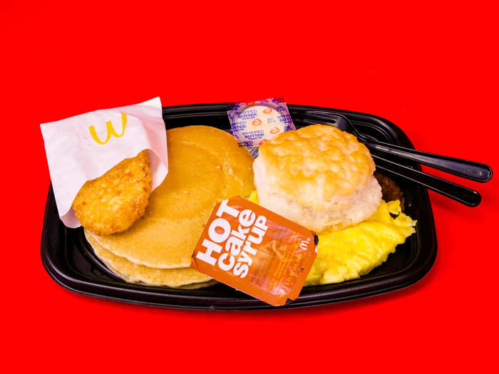 BIG BREAKFAST WITH HOTCAKES, $5.69 — This breakfast platter contains hotcakes, a hash brown, and a deconstructed sausage biscuit with egg.