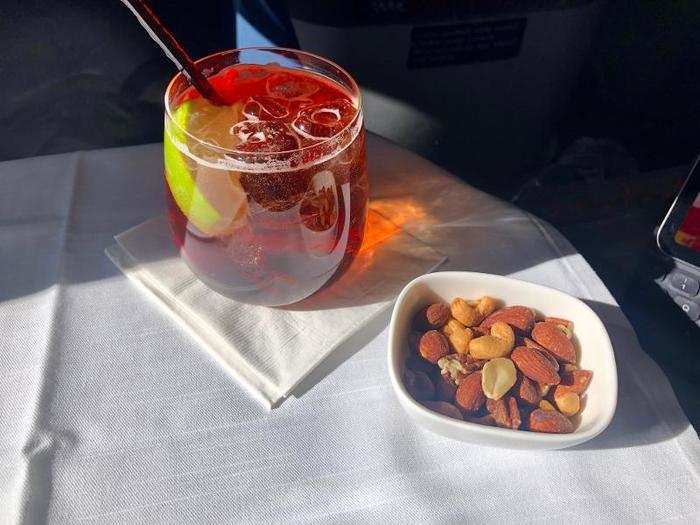 A few minutes later, they came around with the drink cart. I decided to try the signature cocktail, a spiced cranberry bourbon — Woodford Reserve, ginger ale, cran-apple juice, and lime.