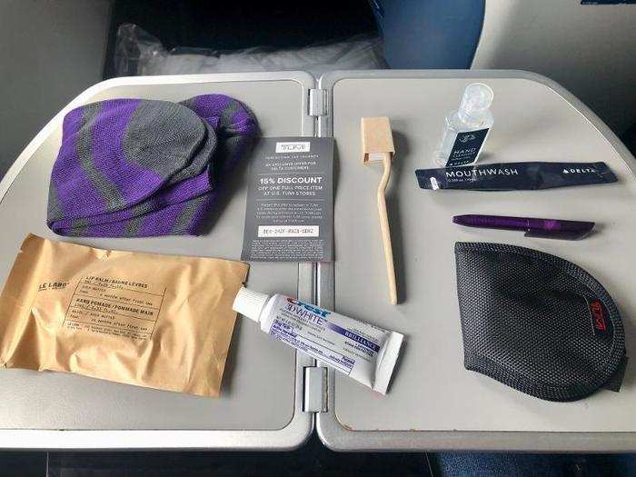 It came with a handful of essentials, like a toothbrush and toothpaste, mouthwash hand sanitizer, a pen, moisturizer, a sleep mask and ear plugs, and socks.