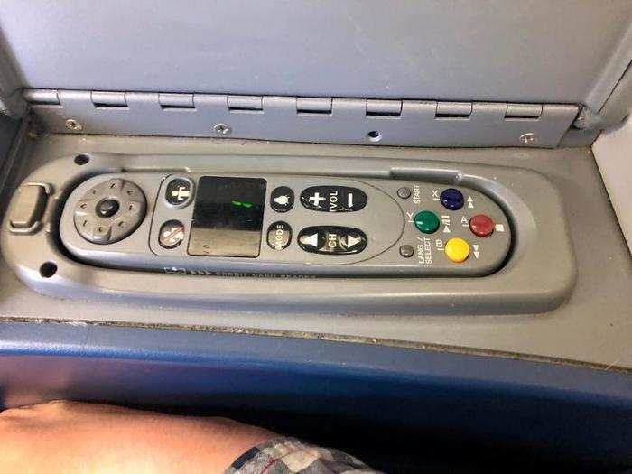 ... While the remote control for the in-flight entertainment system sits under teh adjacent armrest.