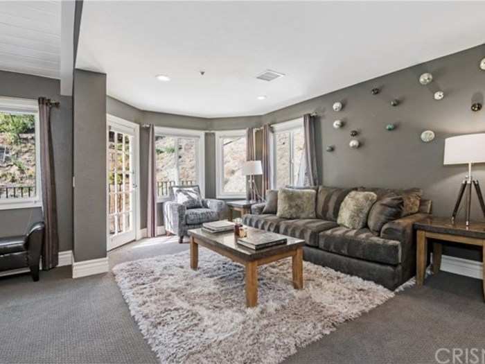 This master bedroom has a comfortable-looking sitting area off to the side.