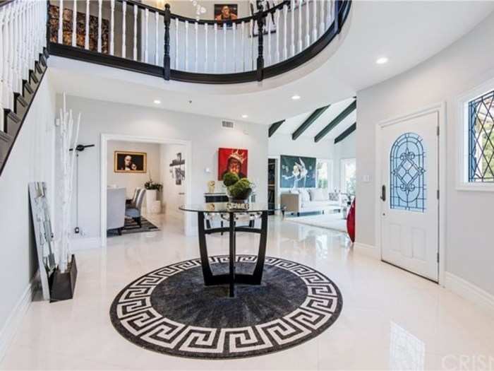 The foyer is large, elegant, and open. It