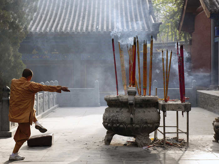 In the Shaolin Temple, a typical day begins at 5.30 a.m. when a young monk walks through the temple beating a wooden board to wake his peers. The monks sleep six to a room.