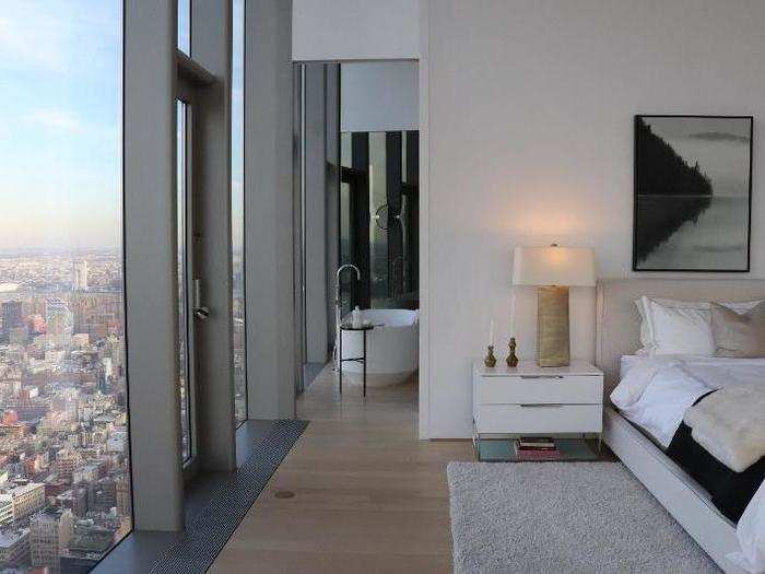 Back inside, the master bedroom seamlessly flows into the master bathroom ...